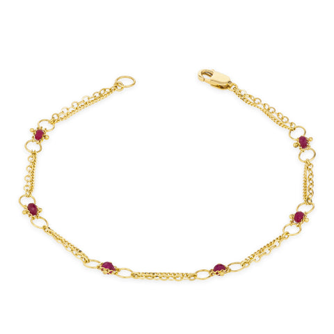 This delicate 18k yellow gold chain bracelet is dotted with ruby beads throughout. The bracelet is finished with a lobster clasp closure.