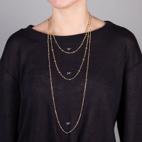 A model wears three delicate chain necklaces with white pearl beads dotted throughout. The necklace is featured in three lengths of 16", 24" and 36"