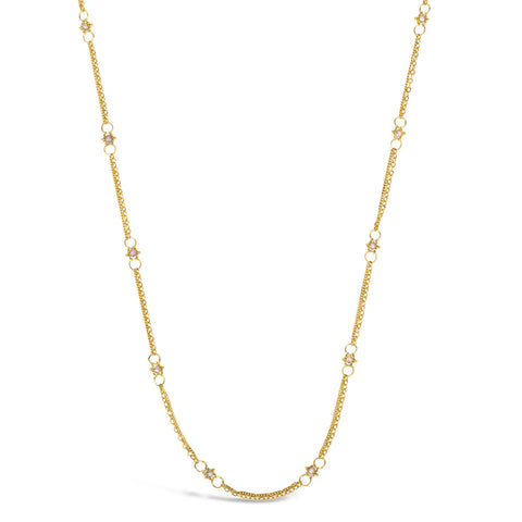 This delicate 18k yellow gold chain necklace is dotted with silver diamond beads throughout. The necklace is finished with a lobster clasp closure.