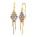 Small tanzanite beads are woven with 18k yellow gold chain in a diamond lattice pattern and have three dangling chains. The earrings are fastened with french hook closures.