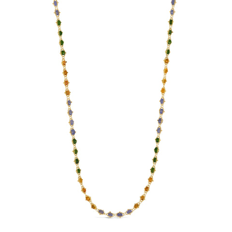 This long 18k yellow gold woven necklace features alternating gemstone beads in Green Tourmaline, Garnet, and Tanzanite.