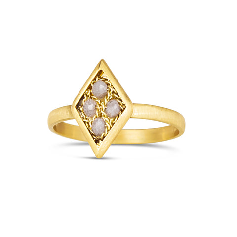 A diamond shaped ring is crafted with four small chain wrapped silver diamonds and set in an 18k yellow gold bezel. The ring is set on a thin band.