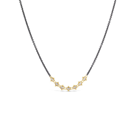A short necklace that is crafted with 18k yellow gold wrapped silver diamonds in the center of an oxidized sterling silver chain.