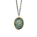 A large carved flower labradorite pendant set in 18k yellow gold on an oxidized sterling silver chain with three off-center blue diamonds in the chain.