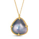 A large irregular shaped pearl with iridescent grey, blue and pink hues is set in a chain wrapped 18k yellow gold bezel with four beaded prongs on a delicate chain.