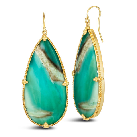 This pair of large teardrop shaped opal earrings feature chain wrapped bezels with four beaded prongs. The stones hang on French hook closures.