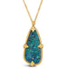 A large teardrop shaped opal with blue and green hues is set in an 18k yellow gold bezel with chain detail and four granulated prongs. The pendant hangs from a delicate chain.