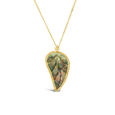This leaf carved Andamooka opal pendant is set in an 18k yellow gold chain wrapped bezel. The pendant hangs from a delicate chain.