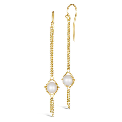 A pair of long 18k yellow gold earrings are crafted with a white pearl suspended between two chains. The earrings are fastened with French hook closures.