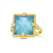 A large square Aquamarine ring is set in an 18k yellow gold bezel wrapped in chain with four beaded prongs. The stone sits on a thin band.