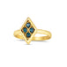A diamond shaped ring is crafted with four small chain wrapped blue diamonds and set in an 18k yellow gold bezel. The ring is set on a thin band.