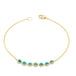 This delicate 18k yellow gold chain bracelet features a row of woven turquoise stones in the center and closes with a lobster clasp.