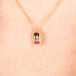 A gradient watermelon tourmaline pendant, with shades of charcoal and pink, is set in an 18k yellow gold chain wrapped bezel and hangs from a delicate chain.