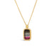 A small rectangular tourmaline pendant, with shades of dark charcoal and pink, is set in an 18k yellow gold chain wrapped bezel and hangs on a thin chain.