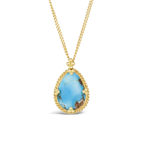 A small teardrop shaped turquoise pendant set in 18k yellow gold with a braided detail and granulated prongs hangs from a short chain.
