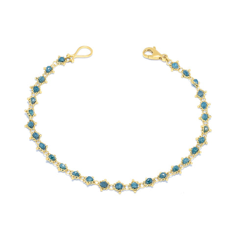 This 18k yellow gold bracelet features blue diamond beads woven throughout a delicate chain. The bracelet features a lobster clasp closure.