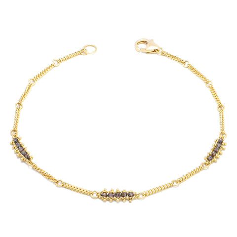 This 18k yellow gold chain bracelet features three champagne diamond bars stationed throughout. The bracelet is finished with a lobster clasp.