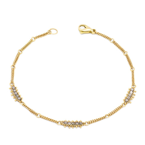 This 18k yellow gold chain bracelet features three silver diamond bars stationed throughout. The bracelet is finished with a lobster clasp.