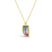 A small dagger shaped watermelon tourmaline pendant, with dark blue and pink hues, is set in an 18k yellow gold chain wrapped bezel. The stone hangs on a delicate chain.