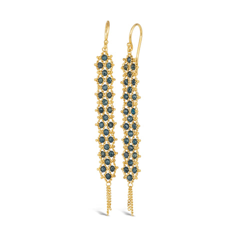 A pair of long blue diamond earrings features a woven lattice pattern and two dangling chains at the bottom of the earring. The earrings fasten with french hook closures.